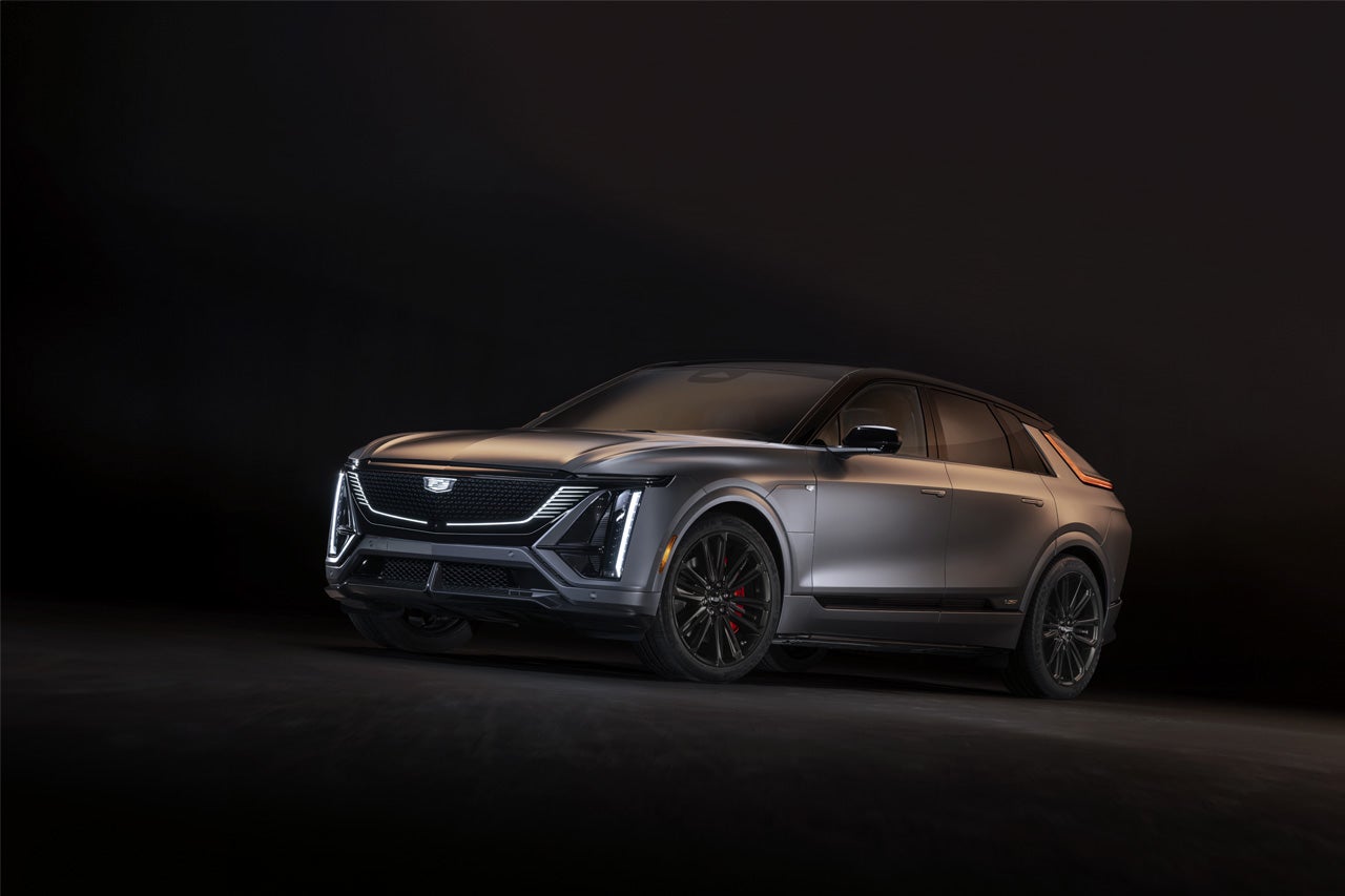 Rear View of the 2025 Cadillac XT4 Driving Fast Through the City at Night